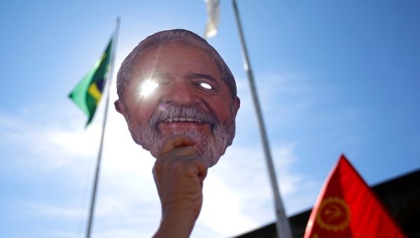 A supporter holds a mask depicting former President Lula da Silva at a protest against Justice Minister Sergio Moro in Brasilia, Brazil June 10, 2019.