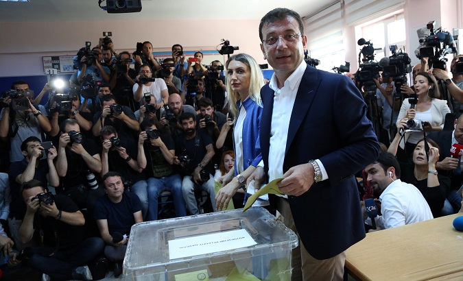 Ekrem Imamoglu, mayoral candidate of the main opposition Republican People's Party (CHP), accompanied by his wife Dilek, casts his ballot at a polling station in Istanbul, Turkey, June 23, 2019.