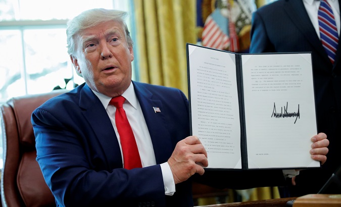 U.S. President Donald Trump displays an executive order imposing fresh sanctions on Iran in the Oval Office of the White House in Washington, U.S., June 24, 2019.