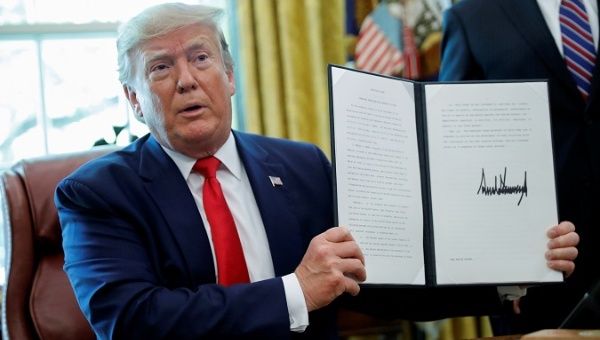 U.S. President Donald Trump displays an executive order imposing fresh sanctions on Iran in the Oval Office of the White House in Washington, U.S., June 24, 2019. 