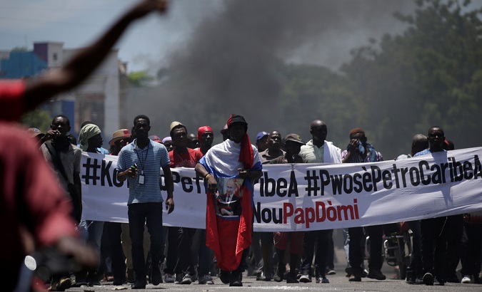 Protesters march during a demonstration against the government of President Jovenel Moise in the streets of Port-au-Prince, Haiti.