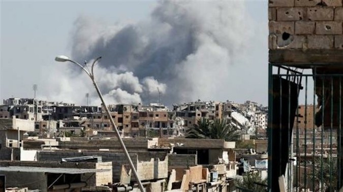 In this file picture, smoke rises near a stadium after an airstrike by the US-led coalition forces, in Raqqah, Syria.