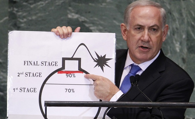 Israeli Prime Minister Benjamin Netanyahu points to a red line he drew on the graphic of a bomb used to represent Iran’s nuclear program.