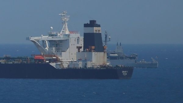 A British Royal Navy patrol vessel guards the oil supertanker Grace 1, that's on suspicion of carrying Iranian crude oil to Syria, as it sits anchored in waters of the British overseas territory of Gibraltar, historically claimed by Spain, July 4, 2019. 