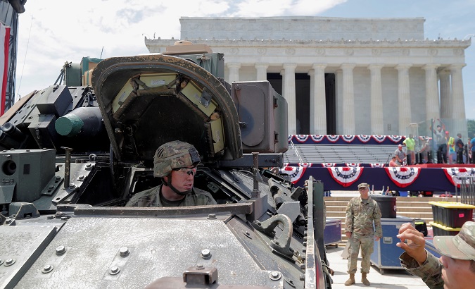 Members of the U.S. Army assist as a Bradley Fighting Vehicle is moved into place at the Lincoln Memorial ahead of a July Fourth celebration.