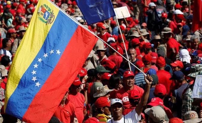 A man waves a Venezuelan national flag as he attends a rally in support of Venezuela's President Nicolas Maduro.
