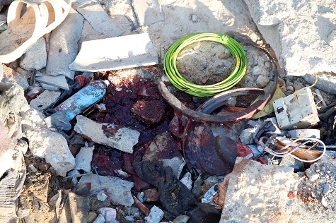 Blood stains are seen amidst debris at detention center that was hit by an airstrike.