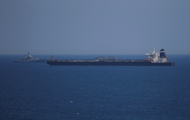 A British Royal Navy patrol vessel guards the oil supertanker Grace 1, that's on suspicion of carrying Iranian crude oil to Syria, as it sits anchored in waters of the British overseas territory of Gibraltar, historically claimed by Spain, July 4, 2019.