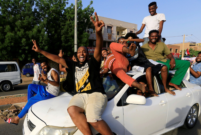 Sudanese people ride atop a car chanting slogans as they celebrate along the streets of Khartoum, Sudan, July 5, 2019.