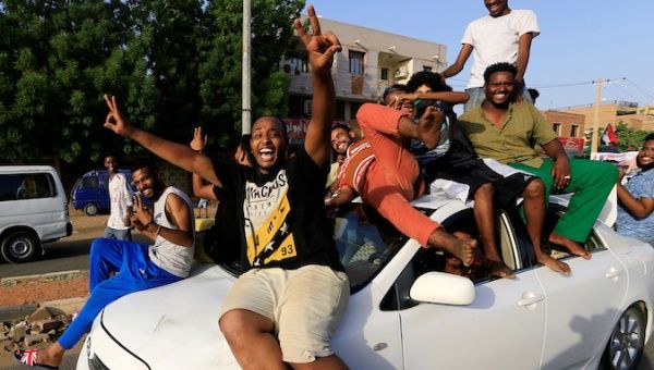 Sudanese people ride atop a car chanting slogans as they celebrate along the streets of Khartoum, Sudan, July 5, 2019. 