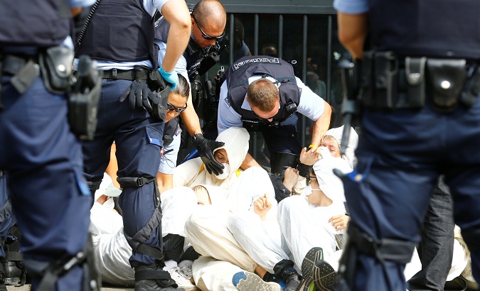 Swiss police officers detain environmental activists blocking the entrance to the headquarters of Swiss bank Credit Suisse in Zurich, Switzerland July 8, 2019.