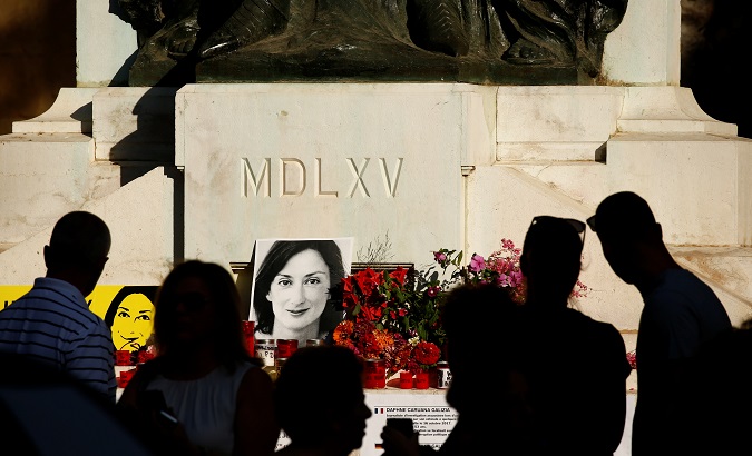 People attend a vigil marking twenty-one months since the assassination of anti-corruption journalist Daphne Caruana Galizia outside the Courts of Justice, after three men were indicted for her murder, in Valletta, Malta July 16, 2019.
