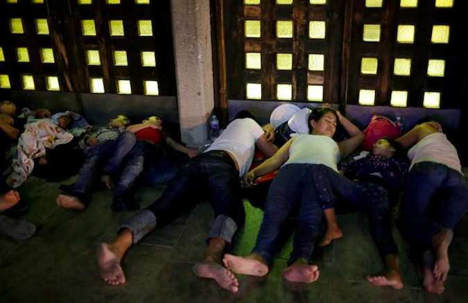 Central American migrants sleep outside the Our Lady of Guadalupe Cathedral in Ciudad Juarez, Mexico, July 14, 2019.