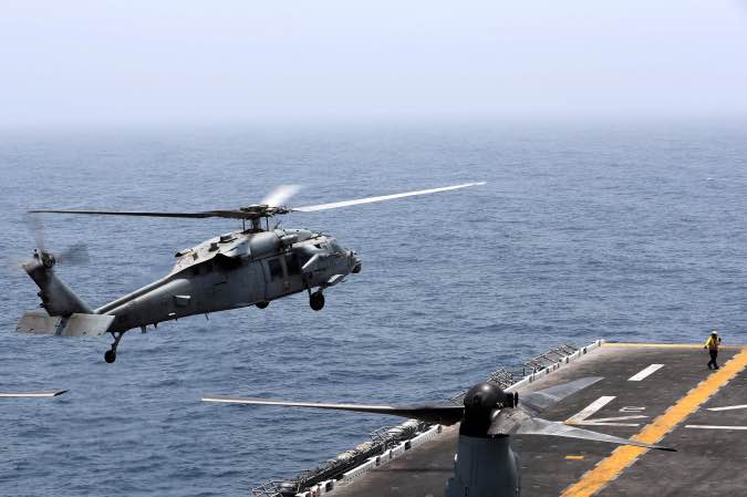 An MH-60S Sea Hawk lands on the flight deck of USS Boxer (LHD-4) in the Arabian Sea off Oman