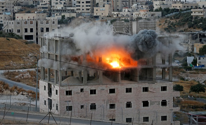 A Palestinian building is blown up by Israeli forces in the village of Sur Baher next to the Israeli barrier in East Jerusalem and the Israeli-occupied West Bank July 22, 2019.