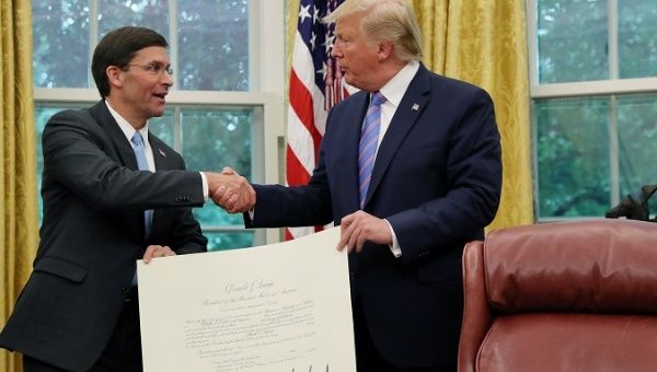 U.S. President Donald Trump shakes hands with Mark Esper after Esper was sworn in as the new secretary of defense on July 23, 2019.