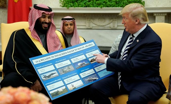 U.S. President Donald Trump holds a chart of military hardware sales as he welcomes Saudi Arabia's Crown Prince Mohammed bin Salman in the Oval Office at the White House in Washington on March 20.