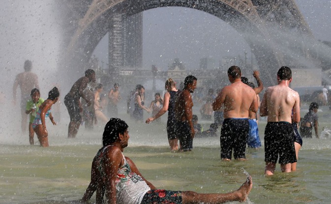 People cool off in the Trocadero fountains in Paris as a new heatwave broke temperature records in France, July 25, 2019