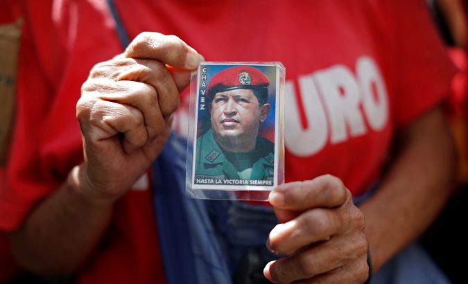 A supporter of Venezuela's President Nicolas Maduro holds a picture of late President Hugo Chavez.