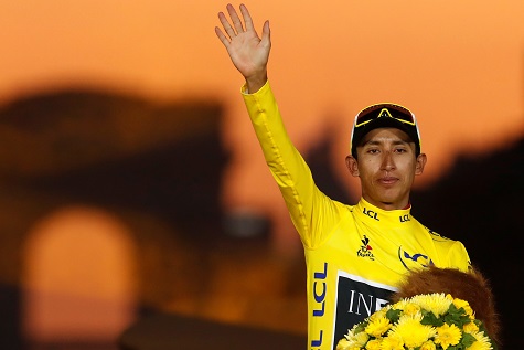 Team INEOS rider Egan Bernal of Colombia celebrates on the podium, after winning the general classification and the overall leader's yellow jersey.