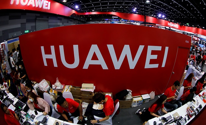Workers sit at the Huawei stand at the Mobile Expo in Bangkok, Thailand May 31, 2019.