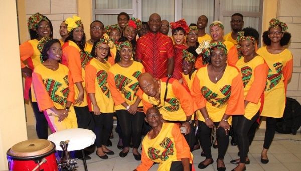 Trinidad and Tobago's Prime Minister Dr. Keith Rowley and his wife, Sharon, take a picture with members of the Shell Invaders Steel Orchestra during an Emancipation Day Celebration Saturday.