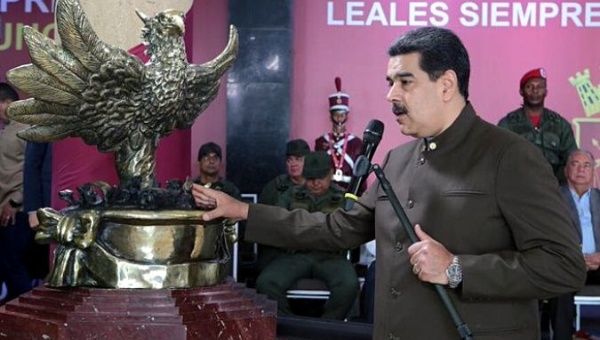 President Nicolas Maduro receives a sculpture of a phoenix from soldiers harmed in the Aug. 4 attack. 