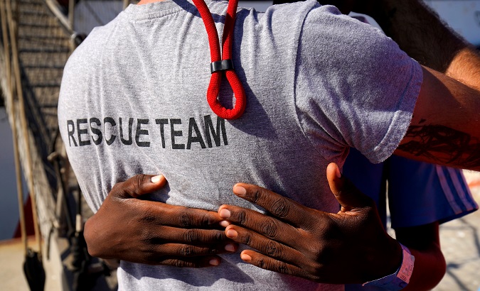 Migrant rescued at the Mediterranean embraces an Open Arms team member in San Roque, Spain, August 9, 2018.