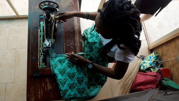 A woman works as a tailor after training with the support of Nigerian charity Pathfinders Justice Initiative in Benin City, Nigeria July 20, 2019.