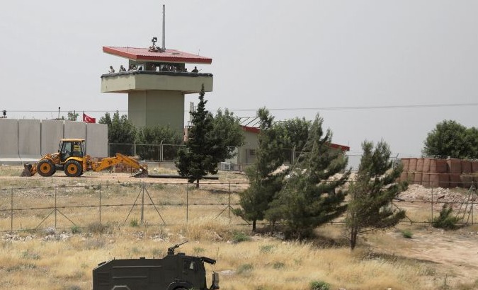 Turkish soldiers stand on a watchtower at the Atmeh crossing on the Syrian-Turkish border.