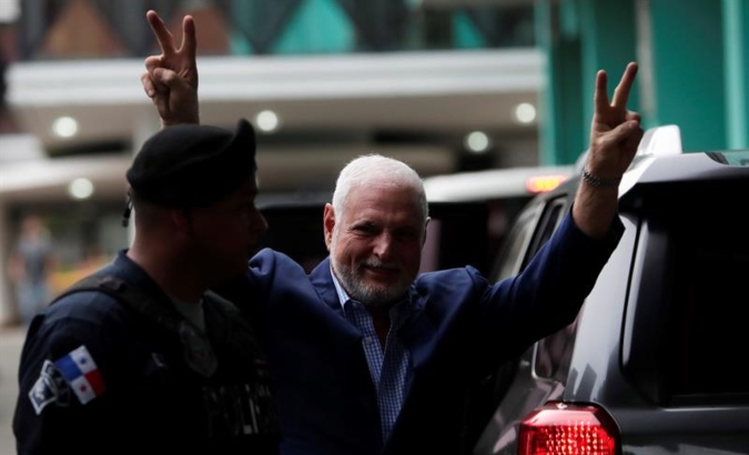 Panamanian ex-president Ricardo Martinelli gives hopeful gesture on his arrival at the Panama Accusatory Criminal System (SPA) on Friday, Aug. 9, 2019 to receive the verdict of his trial.