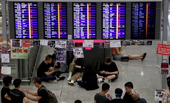 Passengers and demonstrators rest in the arrival hall after flights were cancelled due to the anti-extradition bill protest at Hong Kong Airport, China Aug. 12, 2019.