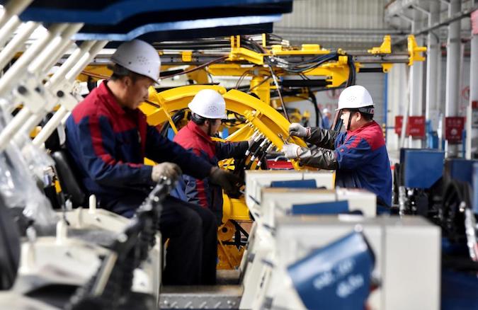 Employees work on a drilling machine production line at a factory in Zhangjiakou, Hebei province, China November 14, 2018.