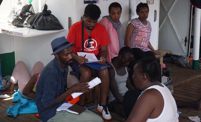 Psychologists provide assistance to migrants at the Open Arms, which remains stranded in the Mediterranean, August 13, 2019.