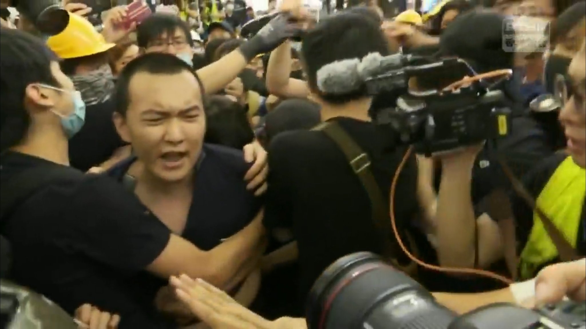 The journalist, Fu Guohao, being attacked by protesters shortly before being tied up.