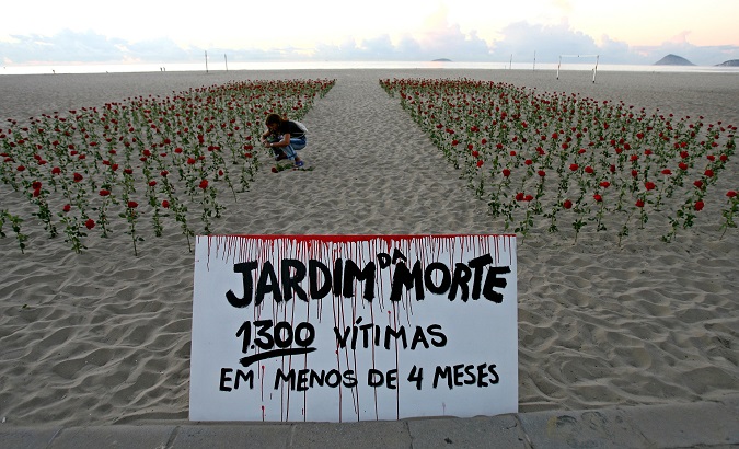 Roses in memory of poor people killed. The banner reads, 'Garden of Death. 1300 people killed in less than four months', Rio de Janeiro, Brazil, Feb, 2007.