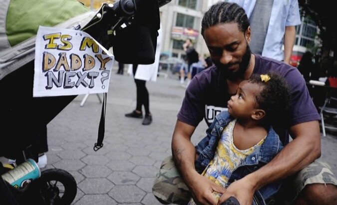 A father holds his daughter during a Black Lives Matter demonstration in Union Square, New York.