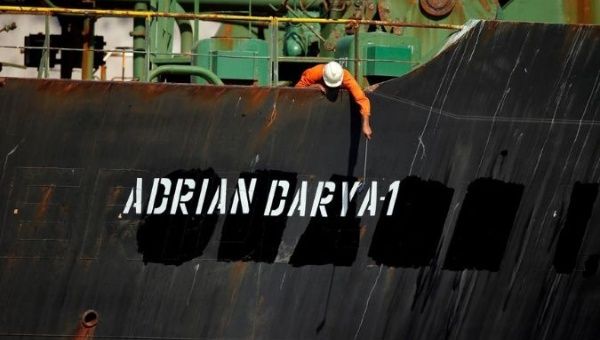 A crew member takes pictures with a mobile phone to Iranian oil tanker Adrian Darya 1, before being named as Grace 1.