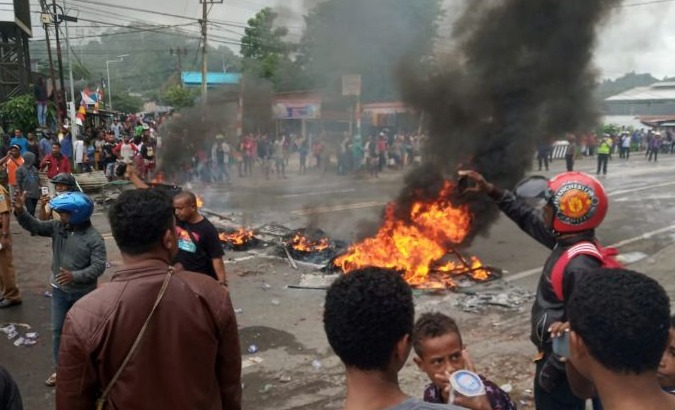 People burn tires during a protest at a road in Manokwari, West Papua, Indonesia, August 19, 2019 .