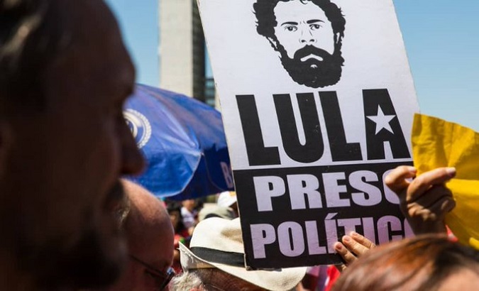 Brazilians holding a sing that reads ‘Lula Political Prisoner’, Brazil, August 20, 2019.
