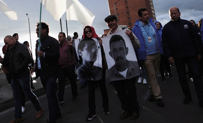 People hold posters with photographs of murdered Colombian social leaders in Bogota, Colombia July 26, 2019.