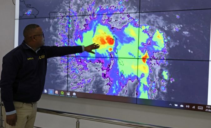 A member of the Emergency Operations Committee (COE) monitors the trajectory of Storm Dorian in Santo Domingo, Dominican Republic August 27, 2019.