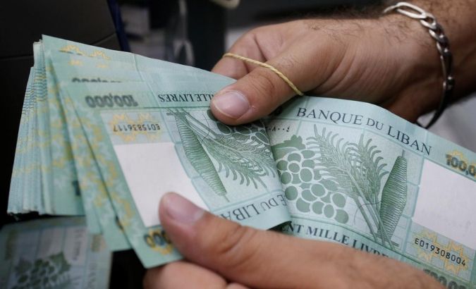 A man counts Lebanese pounds at an exchange office in Beirut, Lebanon, August 16, 2018.