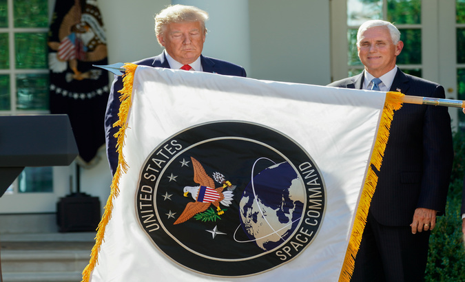 President Donald Trump stands behind a U.S. Space Command flag with Vice President Mike Pence, Washington, U.S., August 29, 2019.