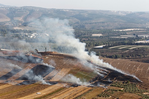 Smoke rises from shells fired from Israel in Maroun Al-Ras village, near the border with Israel, in southern Lebanon.