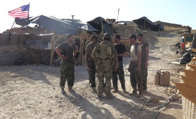 U.S. and Afghan National Army (ANA) soldiers chat with each other at a post in Deh Bala district, Nangarhar province, Afghanistan July 7, 2018.