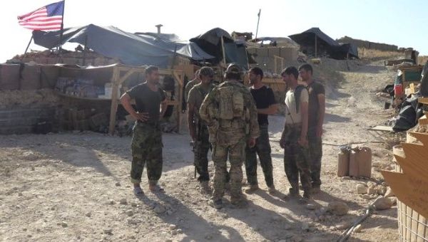 U.S. and Afghan National Army (ANA) soldiers chat with each other at a post in Deh Bala district, Nangarhar province, Afghanistan July 7, 2018. 
