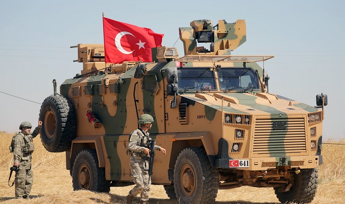 A Turkish soldier walks next to a Turkish military vehicle during a joint U.S.-Turkey patrol, near Tel Abyad, Syria September 8, 2019.