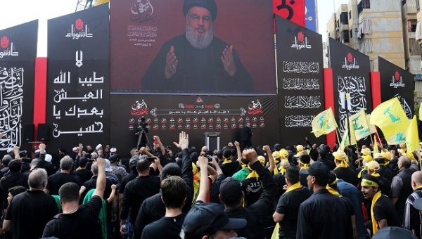 Lebanon's Hezbollah leader Sayyed Hassan Nasrallah gestures as he addresses his supporters via a screen during the religious procession to mark the Shi'ite Ashura ceremony, in Beirut, Lebanon September 10, 2019.