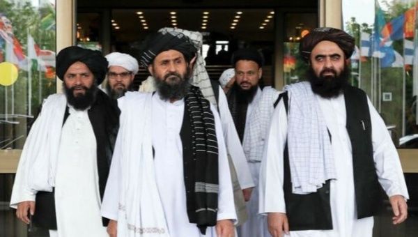 Members of a Taliban delegation, led by chief negotiator Mullah Abdul Ghani Baradar (front), leave after peace talks with Afghan senior politicians in Moscow, Russia May 30, 2019